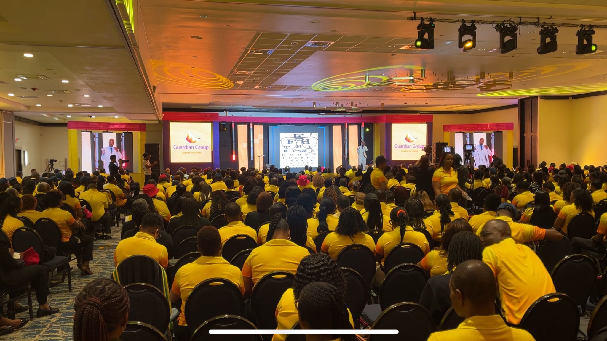 Guardian Group ballroom keynote audience with Dr. Karim R. Ellis on stage